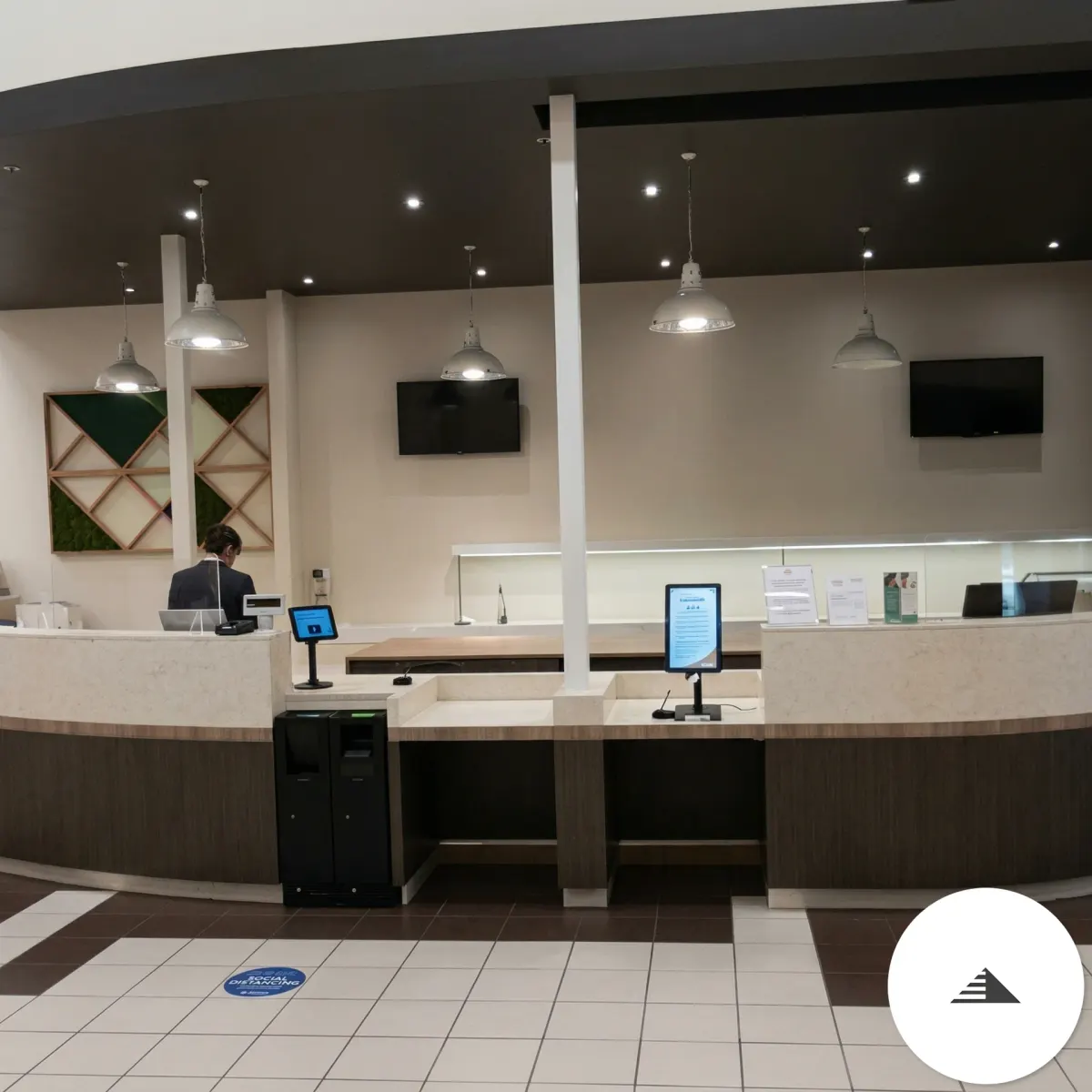 Agencement sur mesure — Vue frontale du comptoir arrondi en fonctionnement avec caisses et écrans installés, galerie marchande E.Leclerc au Pian Médoc | Gonzalez Agencement